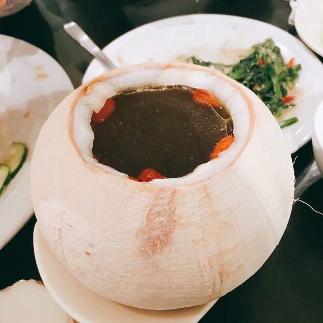 Double boiled whole coconut with black chicken soup